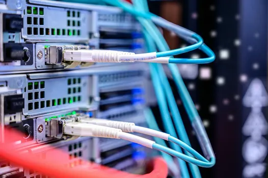 A rack of servers with networking cables running from one to another.